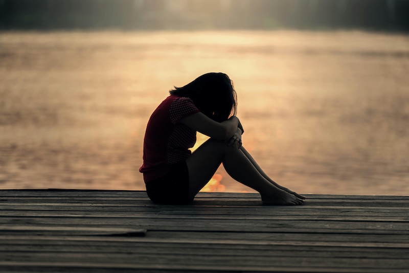 Woman reflecting alone, symbolizing self-reflection in callout vs cancel culture